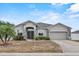 Charming single-story home with stone accents, neutral stucco, and a well-manicured lawn at 491 Majestic Gardens Blvd, Winter Haven, FL 33880
