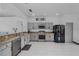 Modern kitchen with stainless steel appliances, tile flooring, and granite countertops at 491 Majestic Gardens Blvd, Winter Haven, FL 33880