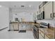 Efficient kitchen layout featuring tile flooring, granite counters, and stainless-steel appliances at 491 Majestic Gardens Blvd, Winter Haven, FL 33880