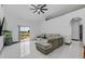 Bright and airy Living Room featuring tile floors, and large glass slider opening to the yard at 491 Majestic Gardens Blvd, Winter Haven, FL 33880
