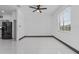 Bright living room with large windows, tile flooring, and a modern ceiling fan at 491 Majestic Gardens Blvd, Winter Haven, FL 33880