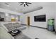 Comfortable living room area with tile flooring, large flat screen TV, and view into the kitchen at 491 Majestic Gardens Blvd, Winter Haven, FL 33880