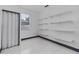 Walk-in closet features vinyl flooring and white shelving units for efficient storage and organization at 491 Majestic Gardens Blvd, Winter Haven, FL 33880