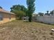 View of backyard with some grass, a partial fence line and a lawnmower at 5030 Silver Thistle Ln, St Cloud, FL 34772