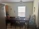 Cozy dining area with a wood table set for four, illuminated by a globe ceiling light at 5030 Silver Thistle Ln, St Cloud, FL 34772