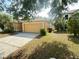 View of the front yard and two-car garage of a single-story home at 5030 Silver Thistle Ln, St Cloud, FL 34772