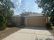 Charming single-story home with a two-car garage and well-maintained front yard at 5030 Silver Thistle Ln, St Cloud, FL 34772