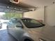 View into an attached garage showing an open door and a parked car at 5030 Silver Thistle Ln, St Cloud, FL 34772