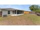 Spacious backyard featuring a screened patio and wood fence at 5210 Silver Thistle Ln, St Cloud, FL 34772