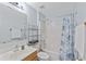 Cozy bathroom with a tub-shower combination, wood vanity, and light blue walls at 5210 Silver Thistle Ln, St Cloud, FL 34772