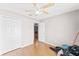 Bedroom with light walls, laminate flooring and ceiling fan, featuring a closet at 5210 Silver Thistle Ln, St Cloud, FL 34772