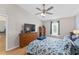 Bedroom featuring a ceiling fan, wood floors, and neutral walls at 5210 Silver Thistle Ln, St Cloud, FL 34772