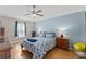 Cozy bedroom featuring a ceiling fan, wood floors, and light blue walls at 5210 Silver Thistle Ln, St Cloud, FL 34772