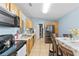 Kitchen and dining area with appliances, wood cabinets, and light blue walls at 5210 Silver Thistle Ln, St Cloud, FL 34772