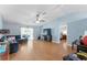 Open-concept living room featuring vaulted ceilings, wood floors, and sliding glass doors to the outdoor patio at 5210 Silver Thistle Ln, St Cloud, FL 34772