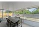 Covered and screened patio with a dining table and backyard view at 5210 Silver Thistle Ln, St Cloud, FL 34772