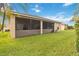 The home has a screened lanai overlooking the lush green lawn, perfect for relaxation at 5253 Pebble Beach Blvd, Winter Haven, FL 33884