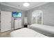 Neutral bedroom design with decorative window, dresser and TV at 5253 Pebble Beach Blvd, Winter Haven, FL 33884