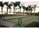 Well-maintained bocce ball court framed by palm trees and lush greenery at 5253 Pebble Beach Blvd, Winter Haven, FL 33884