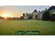 Stunning view of the East Clubhouse with manicured lawn at sunset at 5253 Pebble Beach Blvd, Winter Haven, FL 33884
