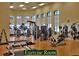 Bright exercise room with modern equipment and plenty of natural light through arched windows at 5253 Pebble Beach Blvd, Winter Haven, FL 33884