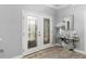 Elegant foyer featuring a glass front door and decorative table with a mirror at 5253 Pebble Beach Blvd, Winter Haven, FL 33884
