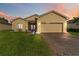 Charming single-story home featuring a well-maintained lawn and brick driveway at 5253 Pebble Beach Blvd, Winter Haven, FL 33884