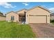 Charming single-story home featuring a well-maintained lawn and brick driveway at 5253 Pebble Beach Blvd, Winter Haven, FL 33884
