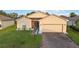 Charming single-story home featuring a well-maintained lawn and brick driveway at 5253 Pebble Beach Blvd, Winter Haven, FL 33884