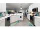 Bright kitchen with white cabinets, stainless steel appliances, and light gray tile flooring at 5253 Pebble Beach Blvd, Winter Haven, FL 33884