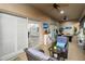 Cozy lanai space featuring comfortable seating, tiled floors, and tranquil views through sliding glass doors at 5253 Pebble Beach Blvd, Winter Haven, FL 33884