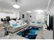 Bright living room featuring white leather couches, blue accents, and an open floor plan at 5253 Pebble Beach Blvd, Winter Haven, FL 33884