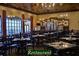 Spacious community restaurant featuring chandeliers, large windows, tables and ample seating at 5253 Pebble Beach Blvd, Winter Haven, FL 33884