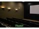 Cozy theater with tiered seating and a large screen for entertainment at 5253 Pebble Beach Blvd, Winter Haven, FL 33884