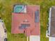 Aerial view showcasing the home's red-tiled roof, solar panels, screened pool, and well-maintained lawn at 5418 Crepe Myrtle Cir, Kissimmee, FL 34758