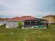 Backyard featuring a pool, patio, and a view of the home's exterior at 5418 Crepe Myrtle Cir, Kissimmee, FL 34758