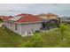 Home exterior with a well-maintained lawn, pool, and solar panels on the roof at 5418 Crepe Myrtle Cir, Kissimmee, FL 34758
