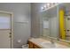 Bathroom with vanity, mirror, and a shower with a yellow shower curtain at 5418 Crepe Myrtle Cir, Kissimmee, FL 34758