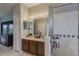 Bathroom featuring double sinks and vanity, shower, and closet at 5418 Crepe Myrtle Cir, Kissimmee, FL 34758