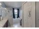 Bathroom with large tub, glass-enclosed shower, and closet at 5418 Crepe Myrtle Cir, Kissimmee, FL 34758