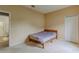 Neutral bedroom featuring carpet floors, a wood bed frame, and a closet at 5418 Crepe Myrtle Cir, Kissimmee, FL 34758