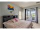 Bedroom features a comfortable bed, balcony access with a view of the outdoors at 5418 Crepe Myrtle Cir, Kissimmee, FL 34758