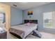 Cozy bedroom featuring a comfortable bed, carpeted floor, and natural light from the window at 5418 Crepe Myrtle Cir, Kissimmee, FL 34758