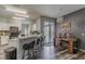 Open kitchen featuring a breakfast bar, modern lighting, and sliding door to the outdoors at 5418 Crepe Myrtle Cir, Kissimmee, FL 34758