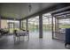 Outdoor patio with dining area overlooking a screened-in pool and serene water view at 5418 Crepe Myrtle Cir, Kissimmee, FL 34758