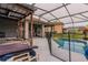Backyard oasis featuring a covered patio, lounge chairs, and a sparkling pool at 5418 Crepe Myrtle Cir, Kissimmee, FL 34758