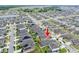 High angle neighborhood view highlighting a community's layout near shops, schools, and natural green scenery at 5876 Bar Ranch Rd, St Cloud, FL 34771