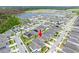 Birds-eye view of a community with homes, green spaces, and a serene lake, near shopping and recreation at 5876 Bar Ranch Rd, St Cloud, FL 34771