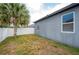 Backyard featuring a tall palm tree alongside a cozy and private space with a white vinyl fence at 5876 Bar Ranch Rd, St Cloud, FL 34771