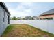 A spacious backyard featuring a white fence, perfect for outdoor activities and privacy at 5876 Bar Ranch Rd, St Cloud, FL 34771